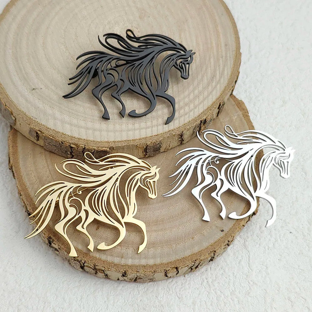 Three horse-shaped metal decorations in black, gold, and silver on wooden slices.