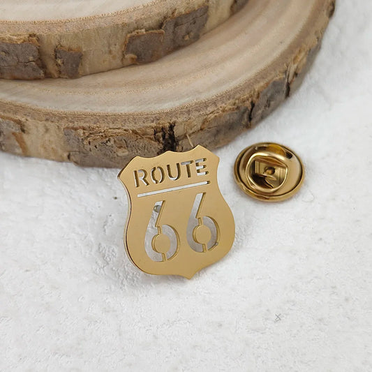 Gold 'ROUTE 66' badge on a textured surface