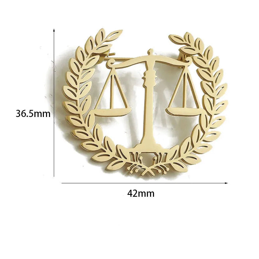 Gold emblem with scales of justice and laurel wreath, showing measurements and material details.