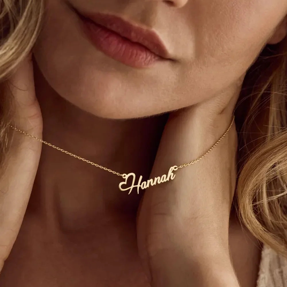 Gold necklace with 'Hannah' pendant worn by a person