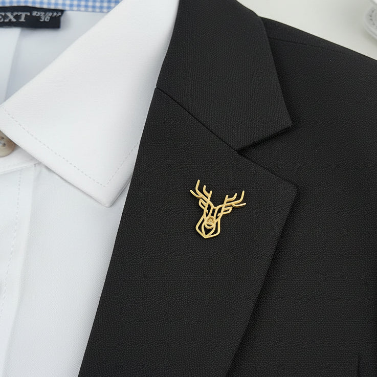 Black blazer with a gold deer head emblem on a white shirt background