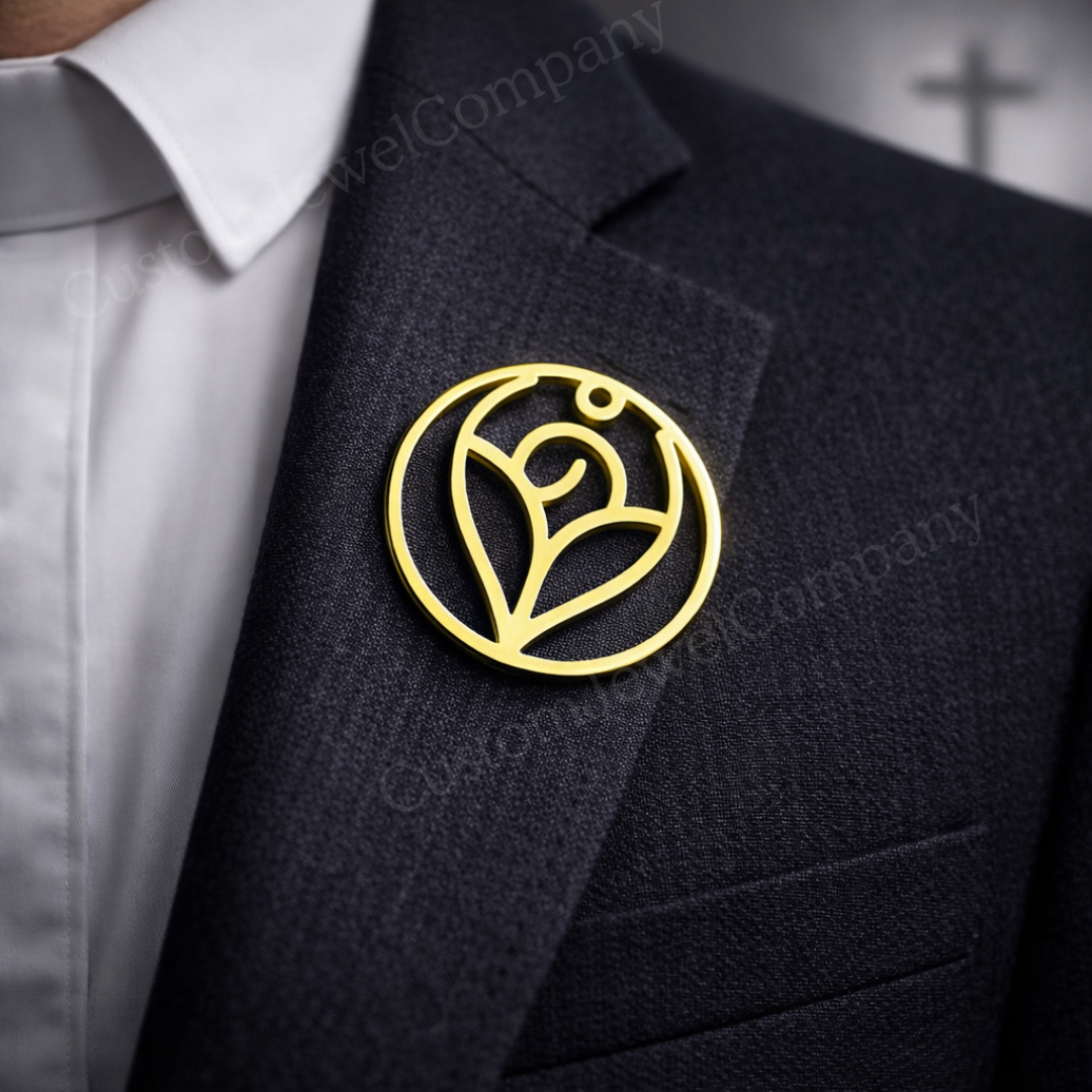 Black suit jacket with a gold brooch featuring a circular design on a blurred background