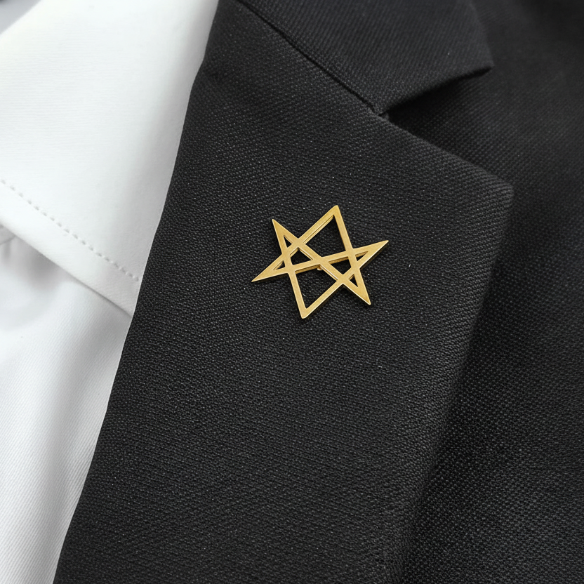 Gold star-shaped lapel pin on a black suit jacket with a white shirt.