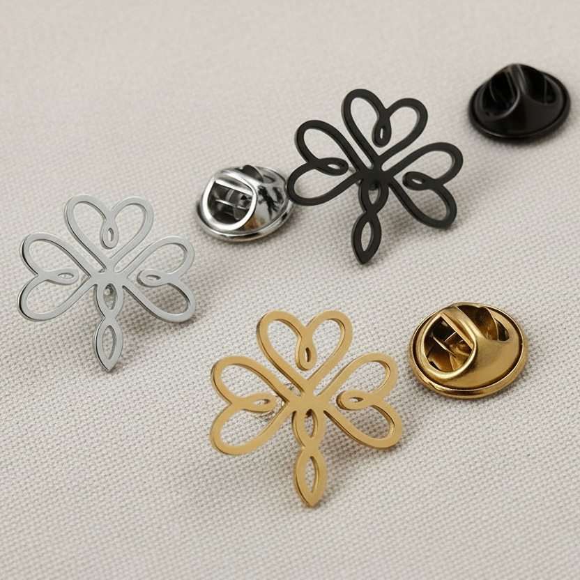 Set of metal flower-shaped pins in various colors on a textured surface