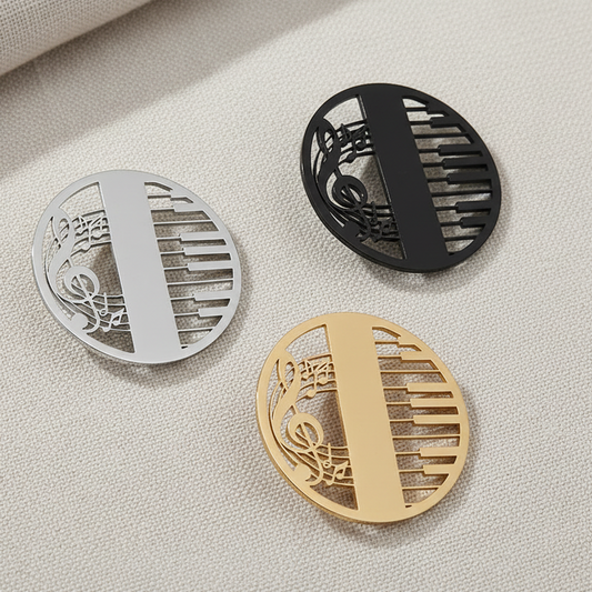 Three decorative coasters in silver, black, and gold on a textured surface