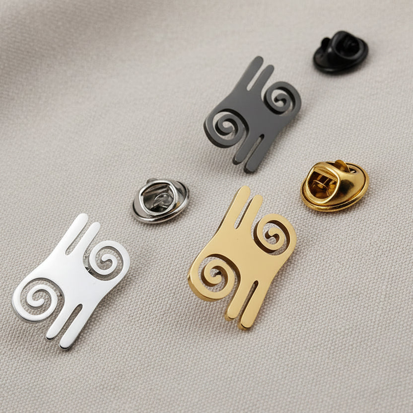 A set of geometric spiral pattern brooch pins for men, displayed in silver and gold colors, suitable for suit lapel accessories.