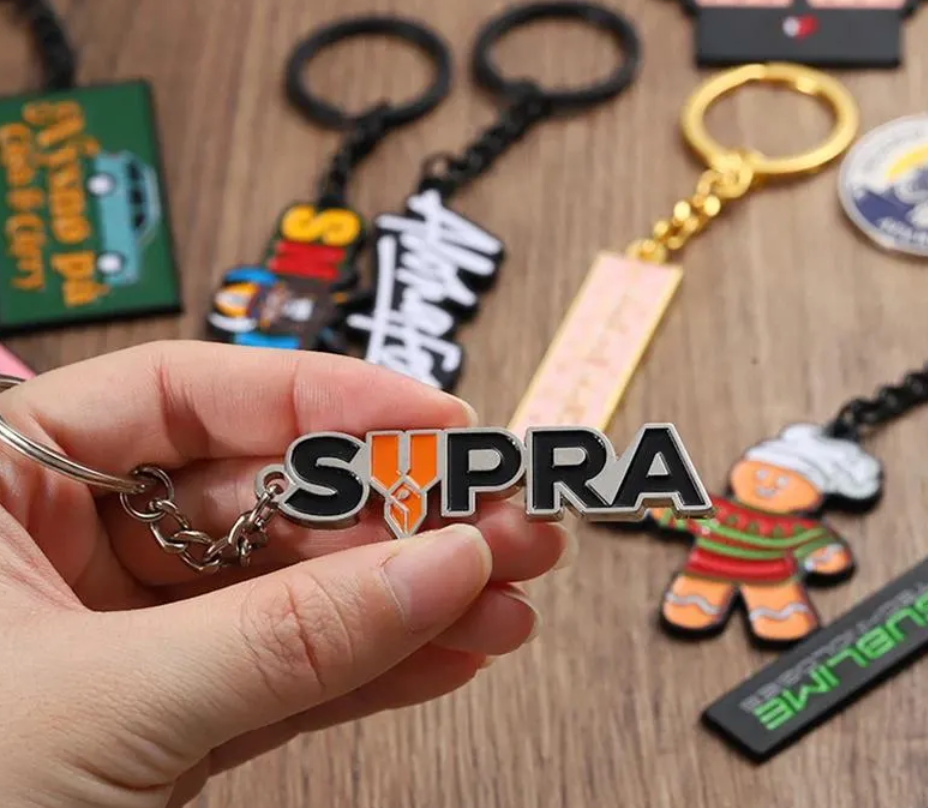 Set of colorful custom logo enamel keychains on a wooden stand.